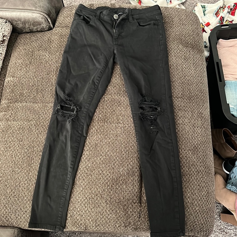 Black ripped American Eagle jeans.